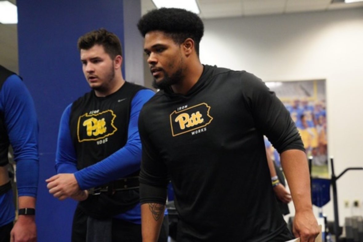 Laron Allen walking through a Division I weight room